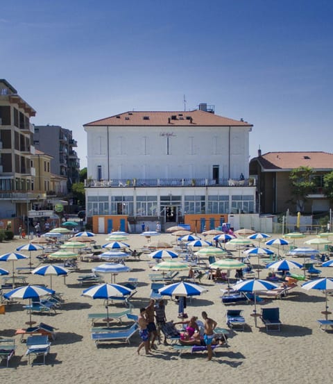 On the beach, white sand, beach umbrellas, beach towels