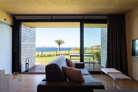 Apartment, Sea View | Living room | Flat-screen TV