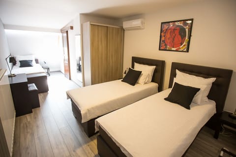 Family Triple Room, 3 Twin Beds | In-room safe, individually furnished, desk, blackout drapes