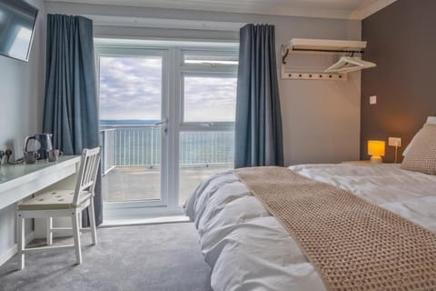 Deluxe Double Room, Balcony, Sea View | Desk, laptop workspace, blackout drapes, iron/ironing board