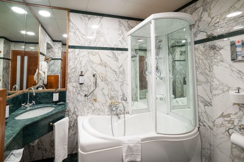 Suite | Bathroom | Deep soaking tub, rainfall showerhead, hair dryer, slippers