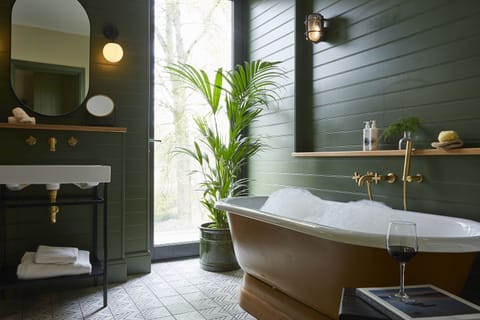 Separate tub and shower, rainfall showerhead, designer toiletries