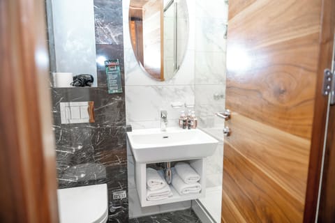 Shower, hair dryer, slippers, towels