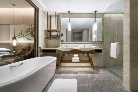 Suite, 1 King Bed | Bathroom | Separate tub and shower, rainfall showerhead, free toiletries