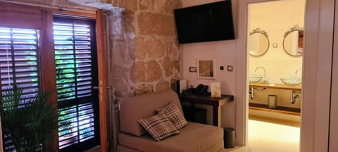 Deluxe Triple Room | Minibar, in-room safe, individually decorated, individually furnished