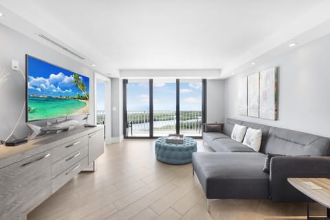 Condo, 1 King Bed with Sofa bed (Elegant beachfront condo in private c) | Living area | Flat-screen TV