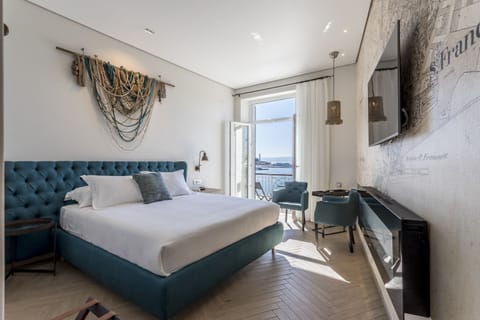 Deluxe Room, Balcony, Sea View | In-room safe, desk, soundproofing, iron/ironing board