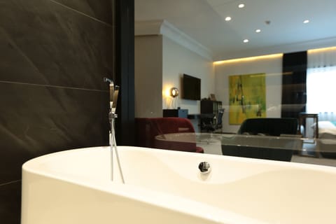 Executive Suite, 1 Queen Bed, City View | Bathroom | Shower, free toiletries, hair dryer, bathrobes