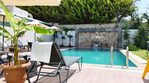 Outdoor pool, open 11:00 AM to 8:00 PM, pool umbrellas, sun loungers