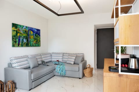 Family Suite, Partial Sea View | Living room | Flat-screen TV