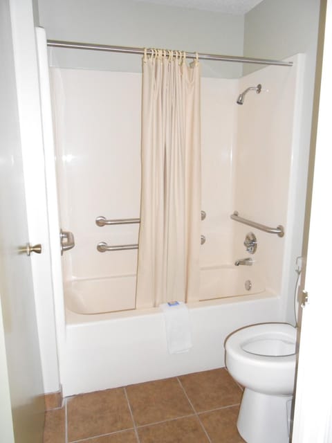 Bathtub, rainfall showerhead, hair dryer, towels