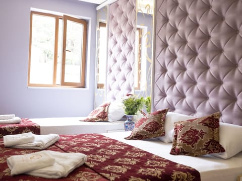 Classic Triple Room, Garden View | Minibar, in-room safe, individually decorated, individually furnished