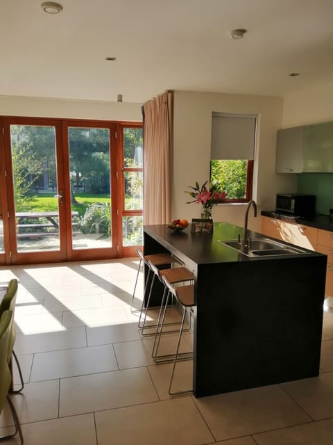 Lodges Self-Catering Garden Area | Private kitchen | Full-size fridge, microwave, oven, stovetop