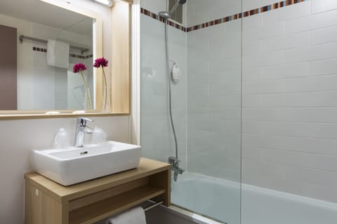 Bathtub, eco-friendly toiletries, hair dryer, towels