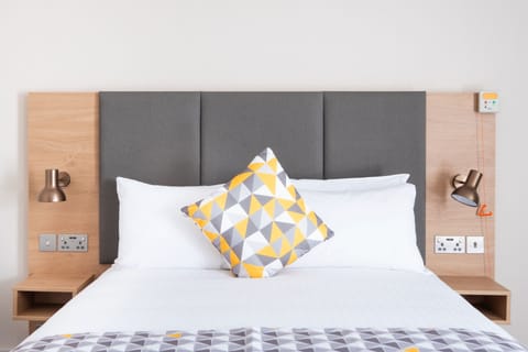 Hypo-allergenic bedding, desk, laptop workspace, blackout drapes