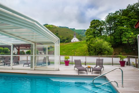 Seasonal outdoor pool, open 10:00 AM to 7:00 PM, pool umbrellas