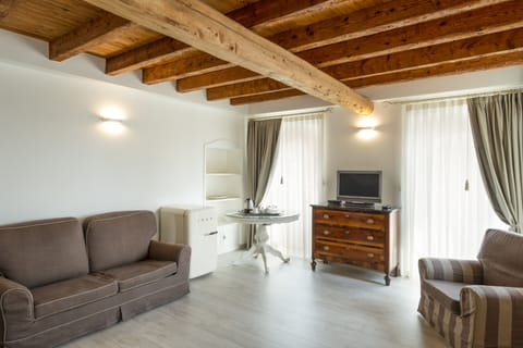 Deluxe Suite, Partial Lake View | Living room | Flat-screen TV