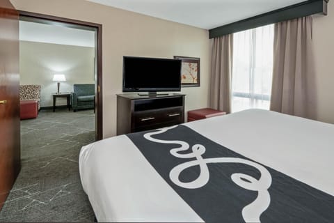 Premium bedding, desk, laptop workspace, blackout drapes