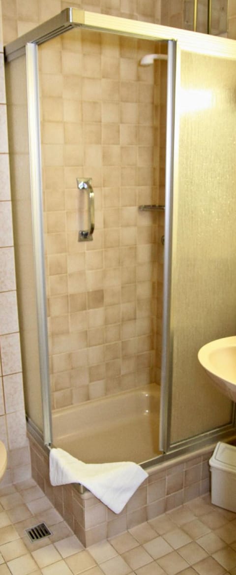 Shower, hair dryer, slippers, towels