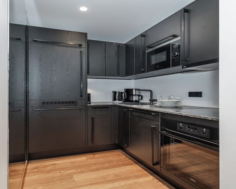 Deluxe Apartment, 1 Bedroom, Balcony, Mountain View | Private kitchen | Fridge, espresso maker, highchair