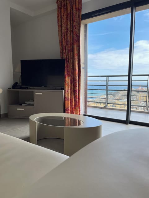 Apartment, Sea View | Living area | Flat-screen TV