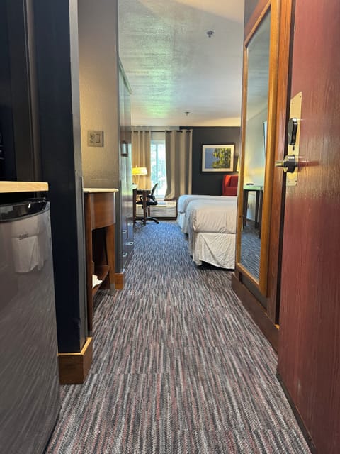 Premium bedding, desk, laptop workspace, blackout drapes