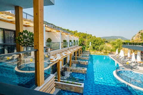 Seasonal outdoor pool, open 8:00 AM to 8:00 PM, pool umbrellas