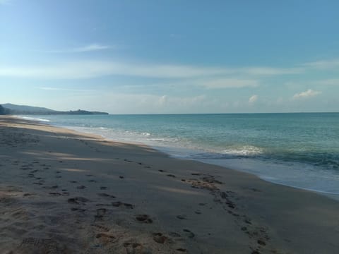 On the beach, white sand, beach towels, 3 beach bars