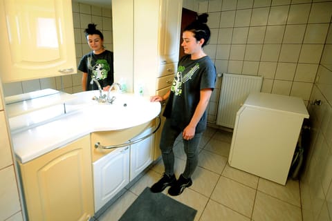 Bathtub, hair dryer, slippers, towels