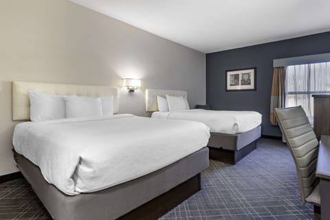 Standard Room, 2 Queen Beds, Non Smoking | Pillowtop beds, desk, iron/ironing board, free cribs/infant beds