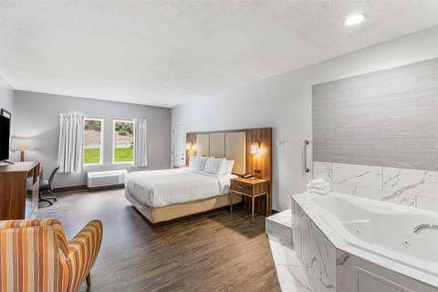 Suite, 1 King Bed, Non Smoking, Jetted Tub (Walk-in Shower) | Desk, laptop workspace, iron/ironing board, free WiFi