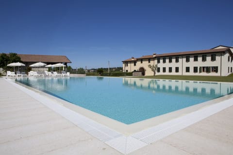 Seasonal outdoor pool, open 8:00 AM to 8:00 PM, pool umbrellas