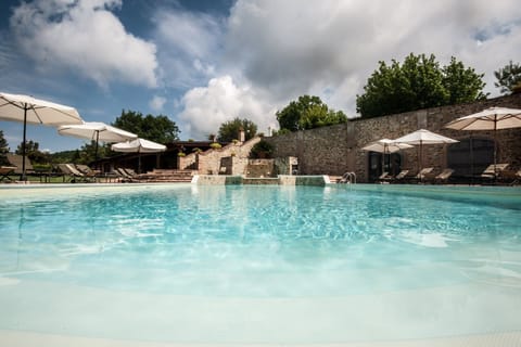 Seasonal outdoor pool, open 9:00 AM to 6:00 PM, pool umbrellas