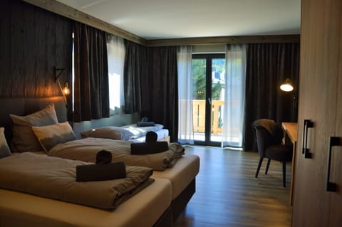 Superior Triple Room | In-room safe, desk, laptop workspace, blackout drapes