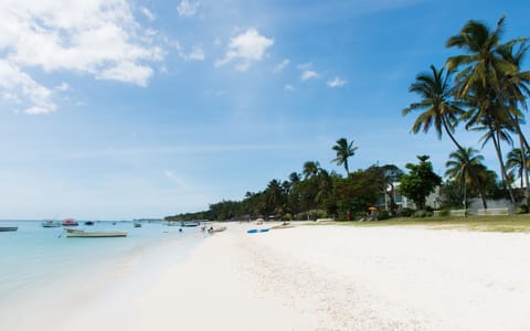 Beach nearby, white sand, beach umbrellas, beach towels