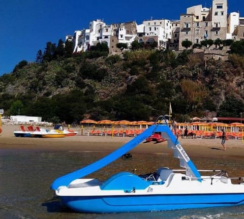 On the beach, white sand, sun loungers, beach umbrellas