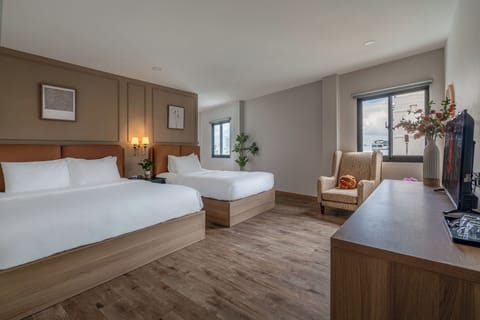 Deluxe Triple Room | Living area | 40-inch flat-screen TV with cable channels, TV