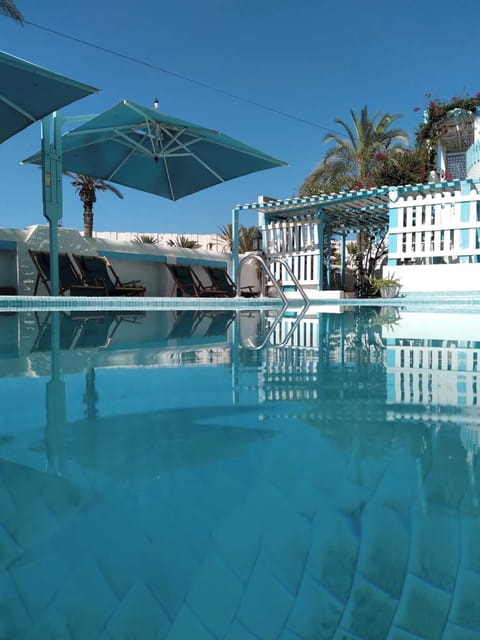 Seasonal outdoor pool, open 10:00 AM to 6:00 PM, pool umbrellas