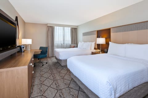 Hypo-allergenic bedding, desk, laptop workspace, blackout drapes