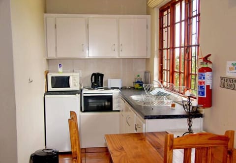 Olive Cottage | Private kitchenette | Coffee/tea maker, electric kettle, highchair