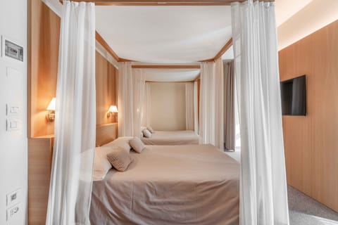 Family Quadruple Room | In-room safe, desk, blackout drapes, iron/ironing board