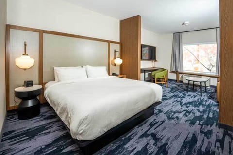 Desk, laptop workspace, iron/ironing board, bed sheets