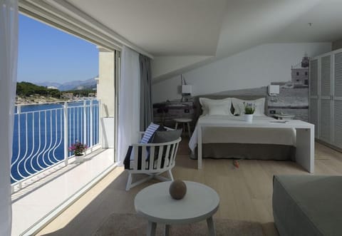 Suite, Sea View | Minibar, in-room safe, desk, blackout drapes