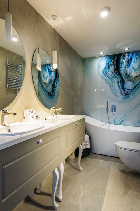 Deluxe Room | Bathroom | Designer toiletries, hair dryer, bathrobes, slippers