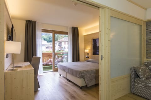 Junior Quadruple Room | 1 bedroom, down comforters, minibar, in-room safe