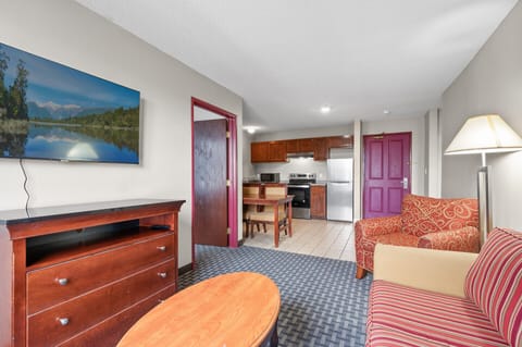 Standard Suite, Kitchen (1 Queen bed & 2 Double beds) | Blackout drapes, iron/ironing board, free WiFi, bed sheets