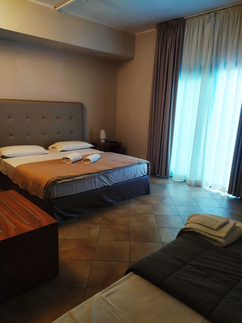 Deluxe Triple Room, Garden View | Minibar, in-room safe, desk, blackout drapes