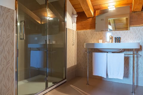 Shower, designer toiletries, hair dryer, bathrobes