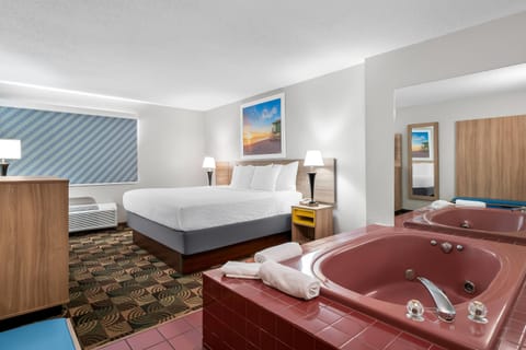 Standard Room, 1 King Bed, Jetted Tub | Desk, iron/ironing board, free cribs/infant beds, rollaway beds