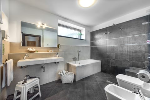 Family Suite, Balcony | Bathroom | Rainfall showerhead, hair dryer, towels, soap